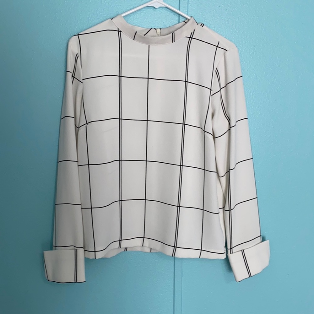 White blouse with black strips.